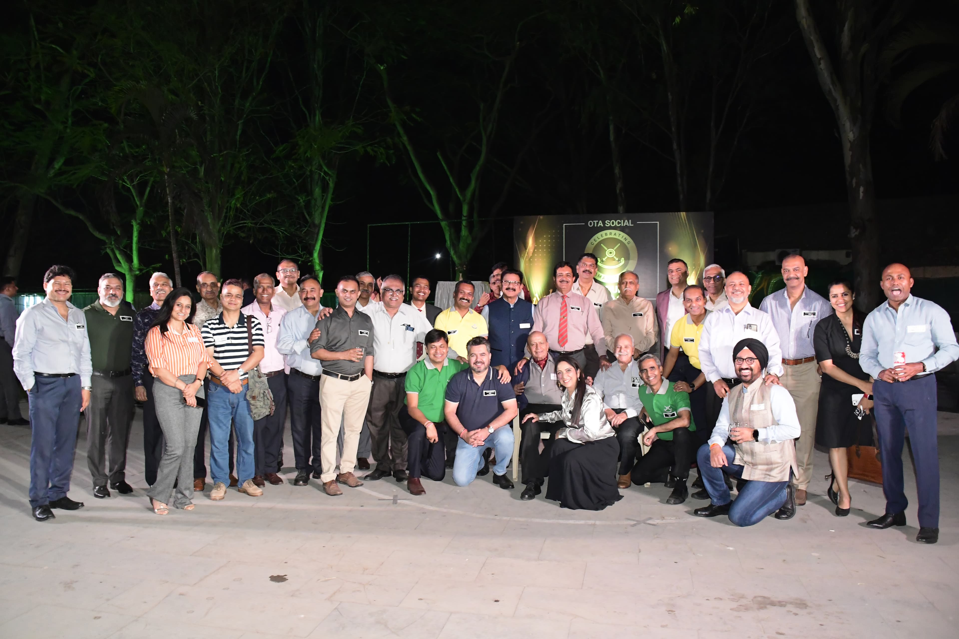 The unnitee community gathered together outdoors at night