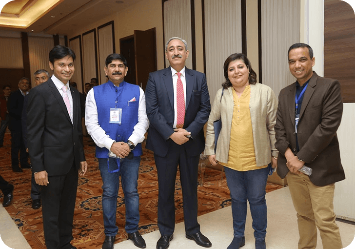 Five conclave attendees posing together in a hotel lobby